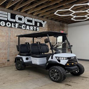 Fresh Powder White Voyager Commander 4 seater forward-facing golf cart with black seats and Eco lithium battery, lifted with independent suspension and four-wheel disc brakes at Velocity Golf Carts in Salt Lake City, Utah